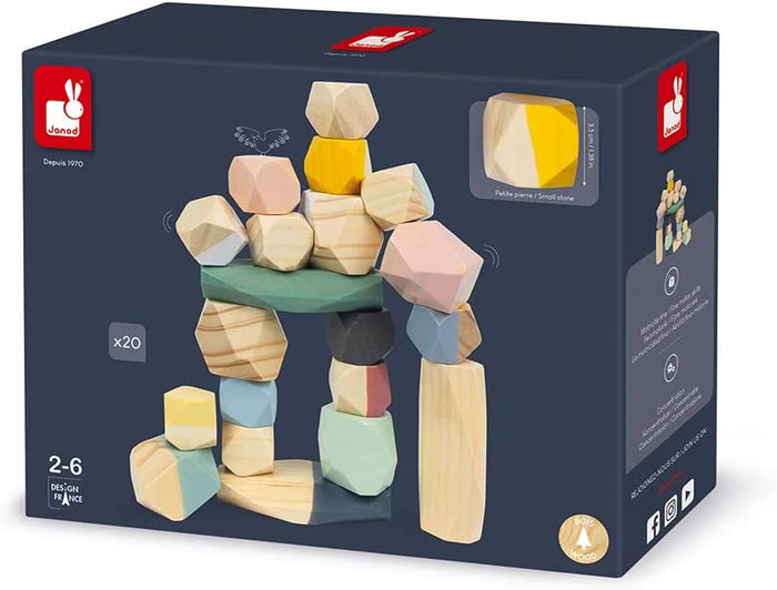 Dark blue toy box featuring 20 faceted wooden blocks in pastel and natural tones, stacked into a balanced tower.