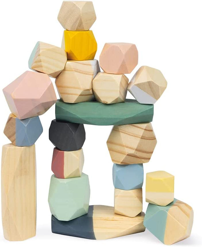 Multicolored faceted wooden stones in pastel and natural wood tones, stacked in a balancing tower on white background.