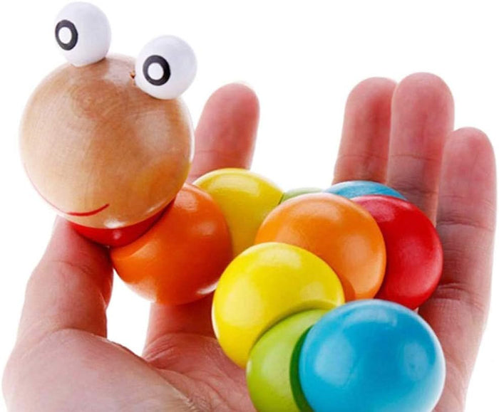Colorful wooden worm toy with twisting round segments and a smiling face held in an open hand.