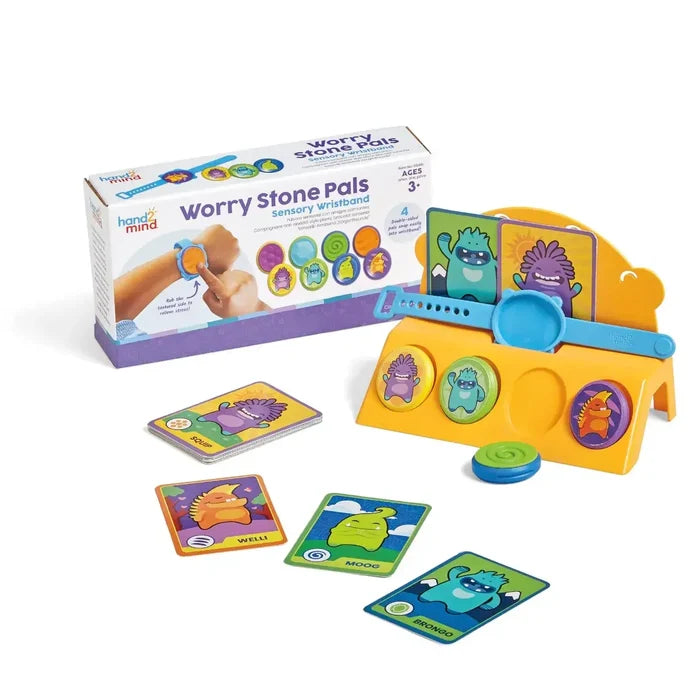 Blue sensory wristband set with four textured monster stones, cards, and yellow stand beside the product packaging.