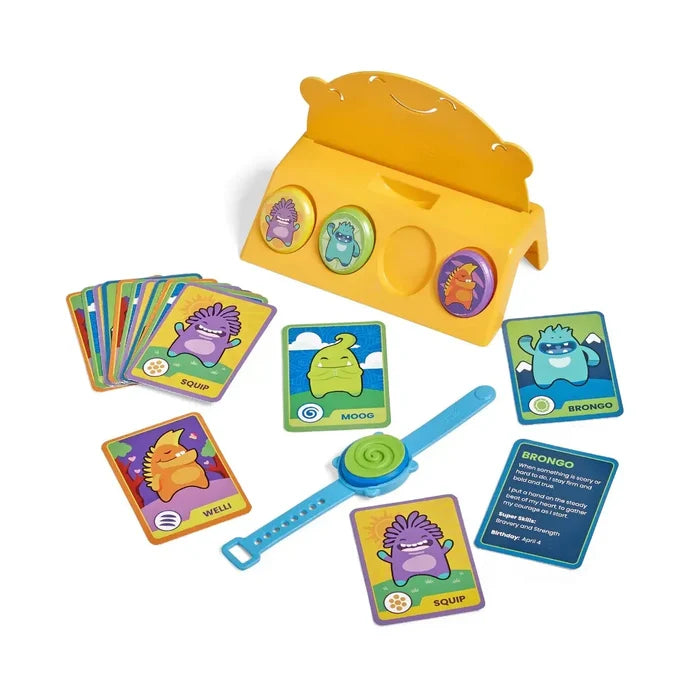 Yellow stand with monster sensory stones, colorful character cards, and a blue silicone wristband.