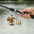 YUMOSHI fishing reel by dealonline.co.nz, close-up of black and silver reel with handle and spool for freshwater or saltwater fishing.