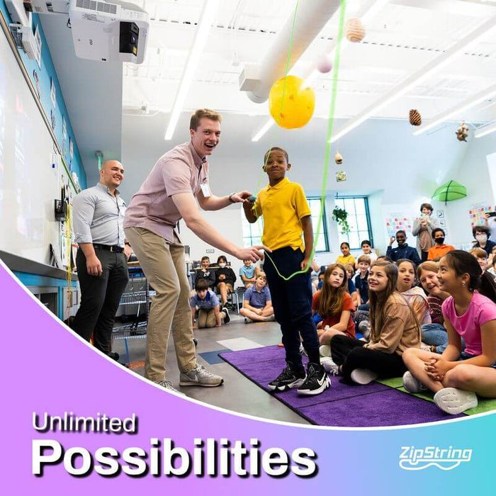 A boy uses a ZipString toy to create a bright neon yellow loop in a classroom while other children watch.